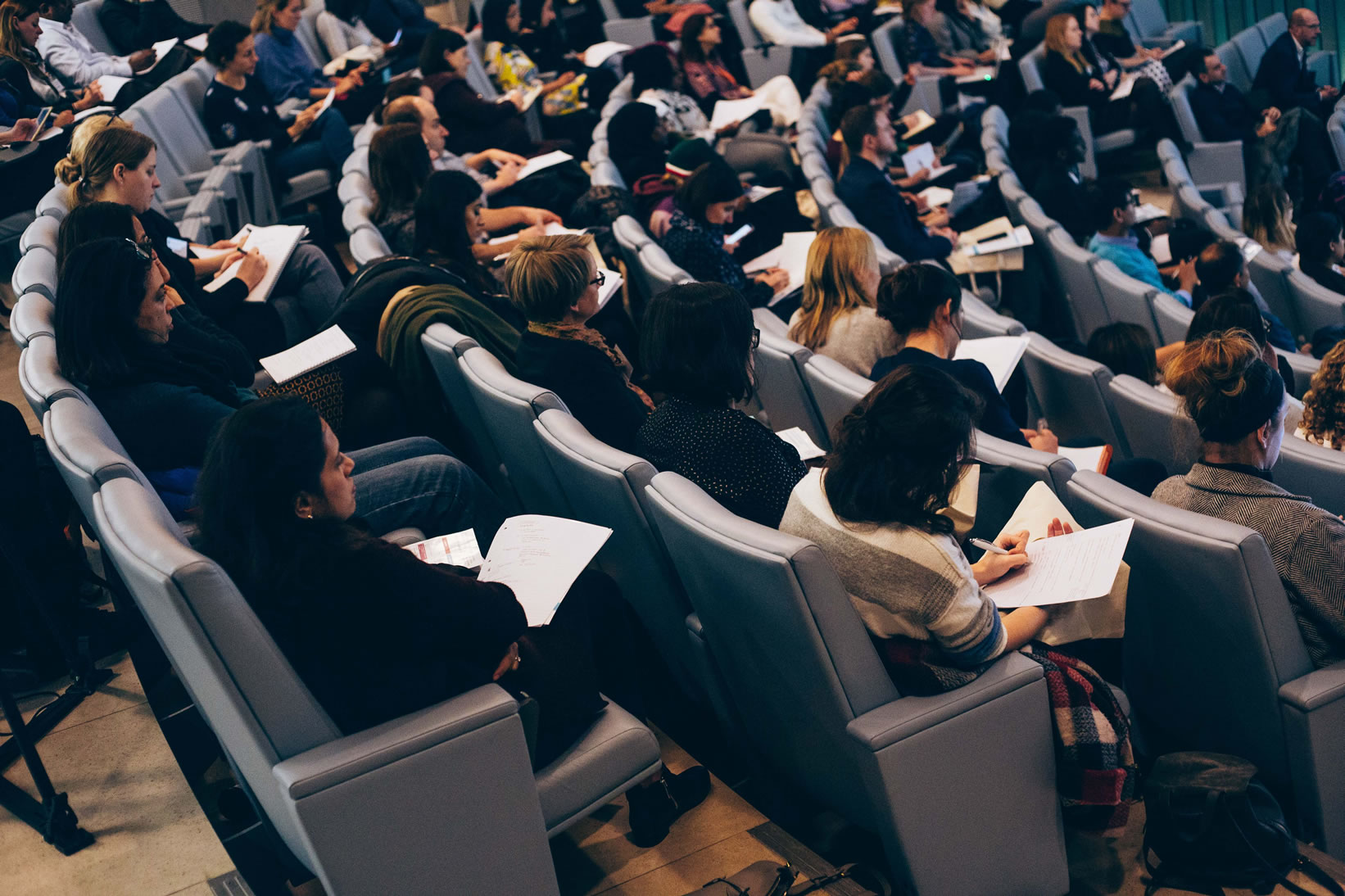 Conference delegates listening and taking notes